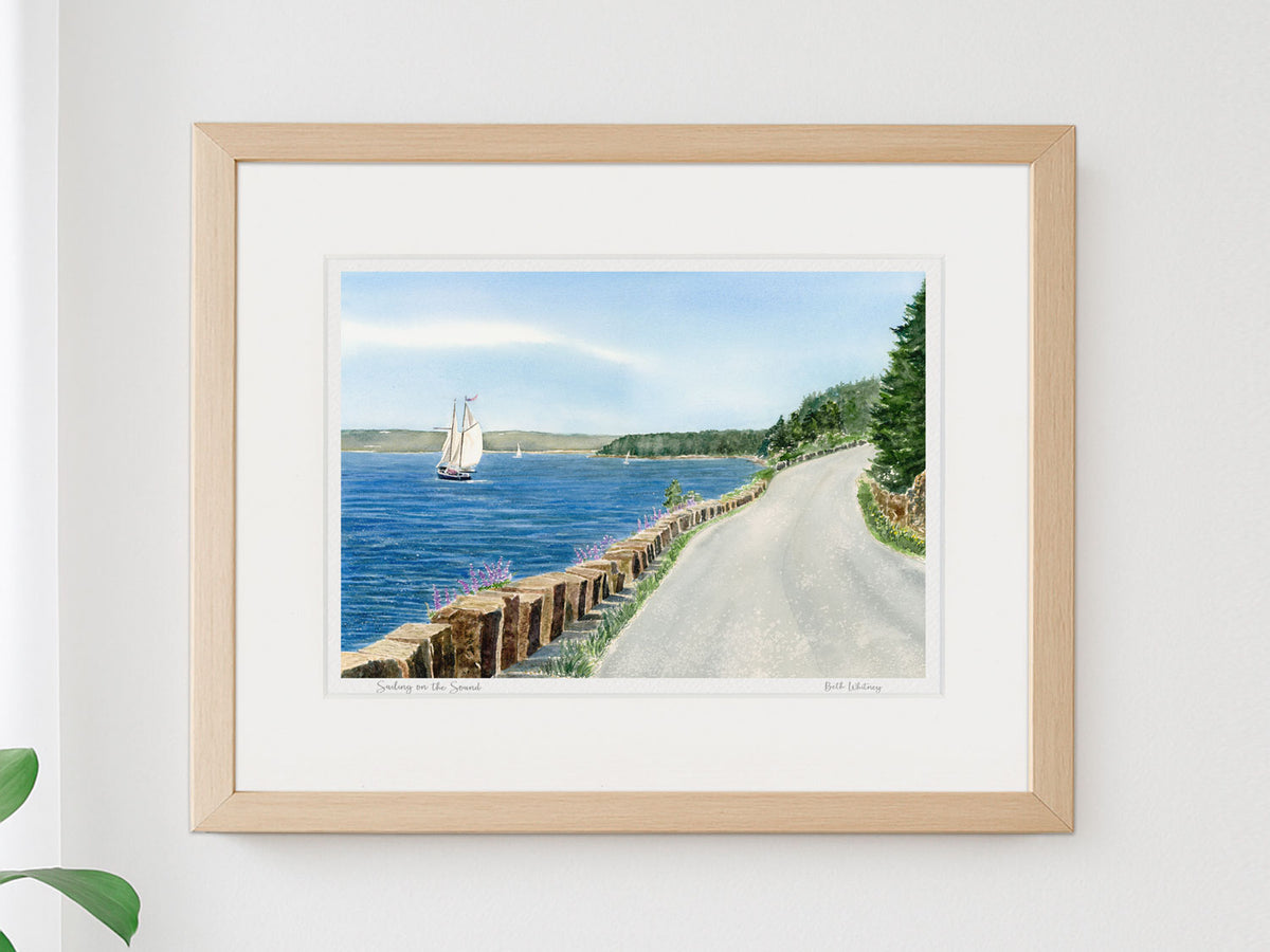 Framed watercolor print of Sailing on the Sound, Somes Sound, Maine, in a warm wood frame on a neutral wall.