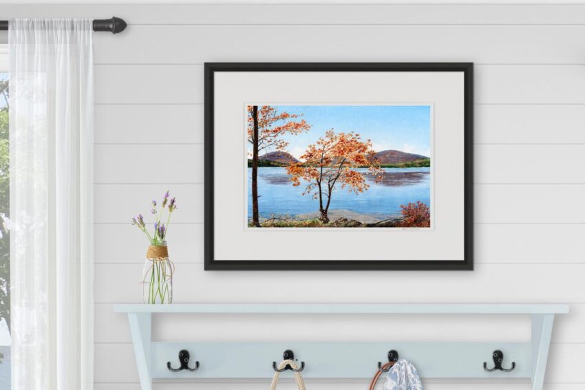 Watercolor painting print of orange trees and purple mountains reflecting in a blue lake.