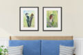 Porch with watercolor bird prints of downy woodpecker and green heron over a wood bench with blue cushions
