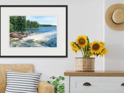 living room with sunflowers and a framed watercolor painting of whitewater rapids