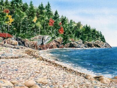 Watercolor of rocky beach with ocean and fall foliage.