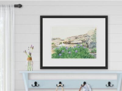 Mudroom with blue coatrack and framed watercolor of rocky shoreline with purple irises in fog.