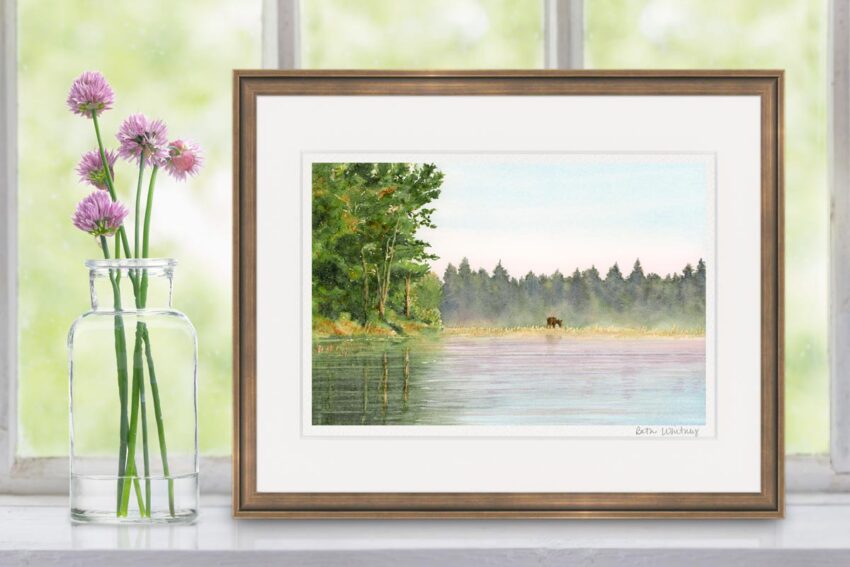 Watercolor painting of a moose at the edge of a pond with trees.