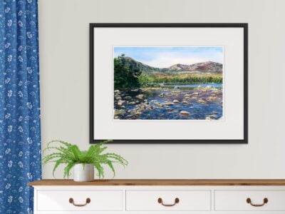 Dresser with painting of Mt Katahdin overlooking Sandy Stream Pond with rocks and reflections.
