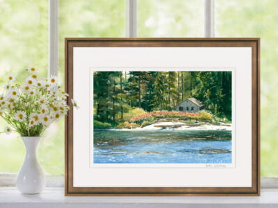 Sparkly ocean, white beach, sunlit trees, and old cabin.