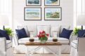Gallery wall of Midcoast Maine seascapes in a nautical style living room